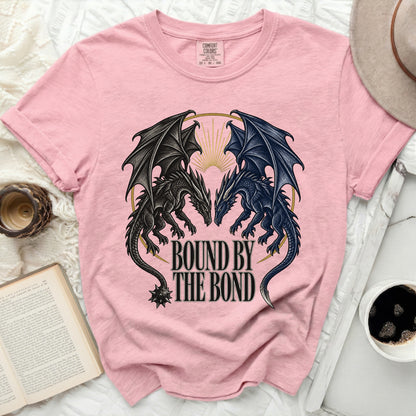 Pink t-shirt with black and blue dragons and text "BOUND BY THE BOND".