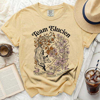 Yellow t-shirt with "Team Elucien" and a fox with flowers design.