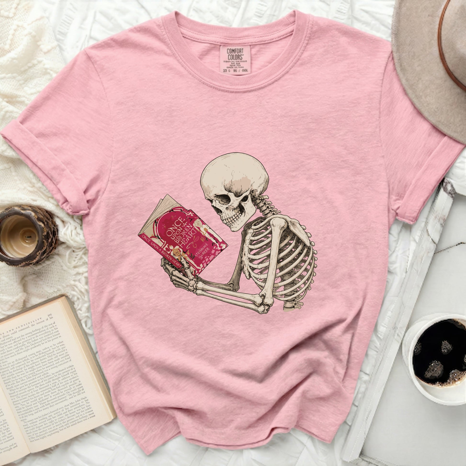 Pink t-shirt with a skeleton reading "Once Upon a Broken Heart".
