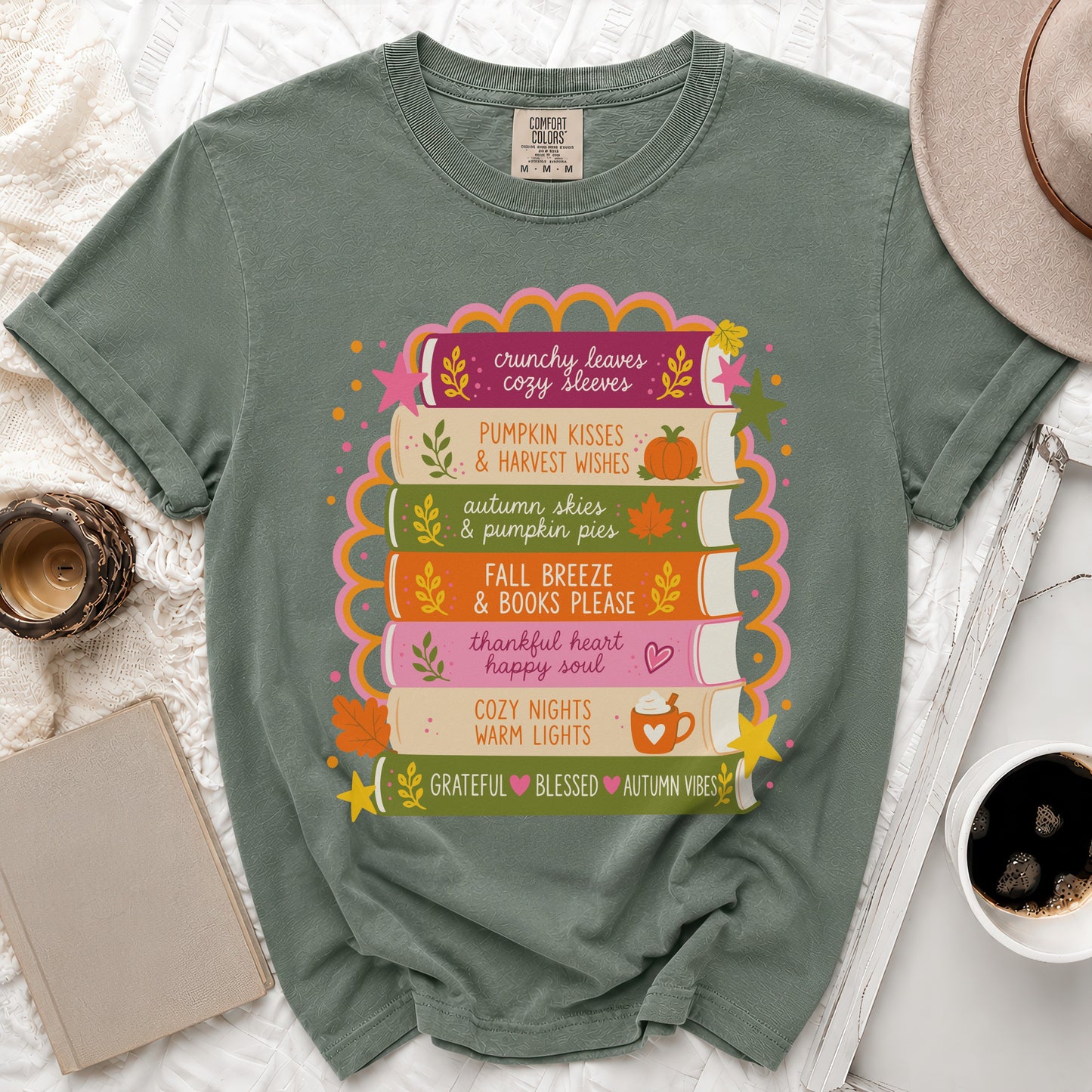 Green t-shirt with stacked books graphic and fall phrases.
