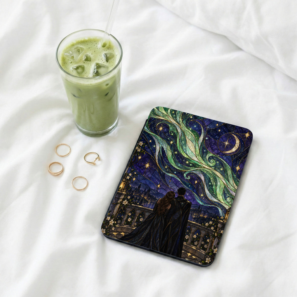 Book cover with couple looking at starry sky over city, near glass of matcha.
