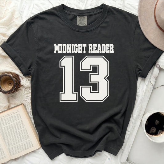 Black t-shirt with "MIDNIGHT READER 13" graphic.