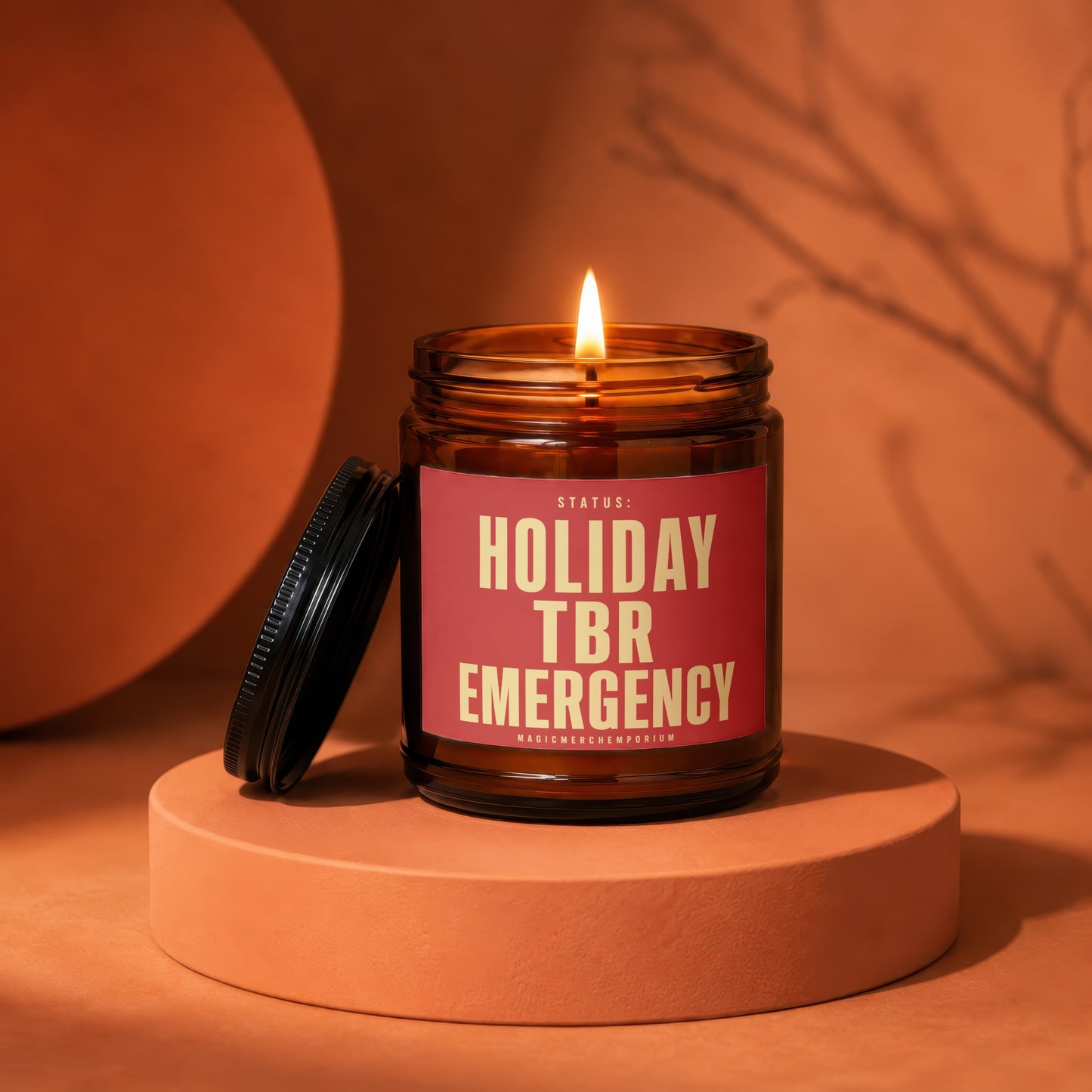 Amber jar candle with lit flame, displaying "Holiday TBR Emergency" text.