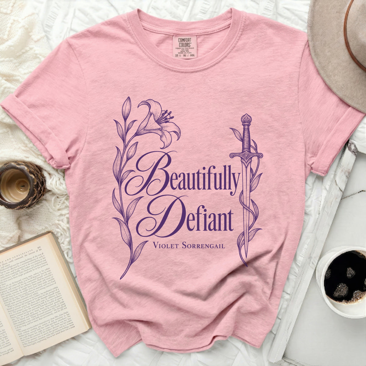 Pink t-shirt with "Beautifully Defiant Violet Sorrengail" text and floral design.