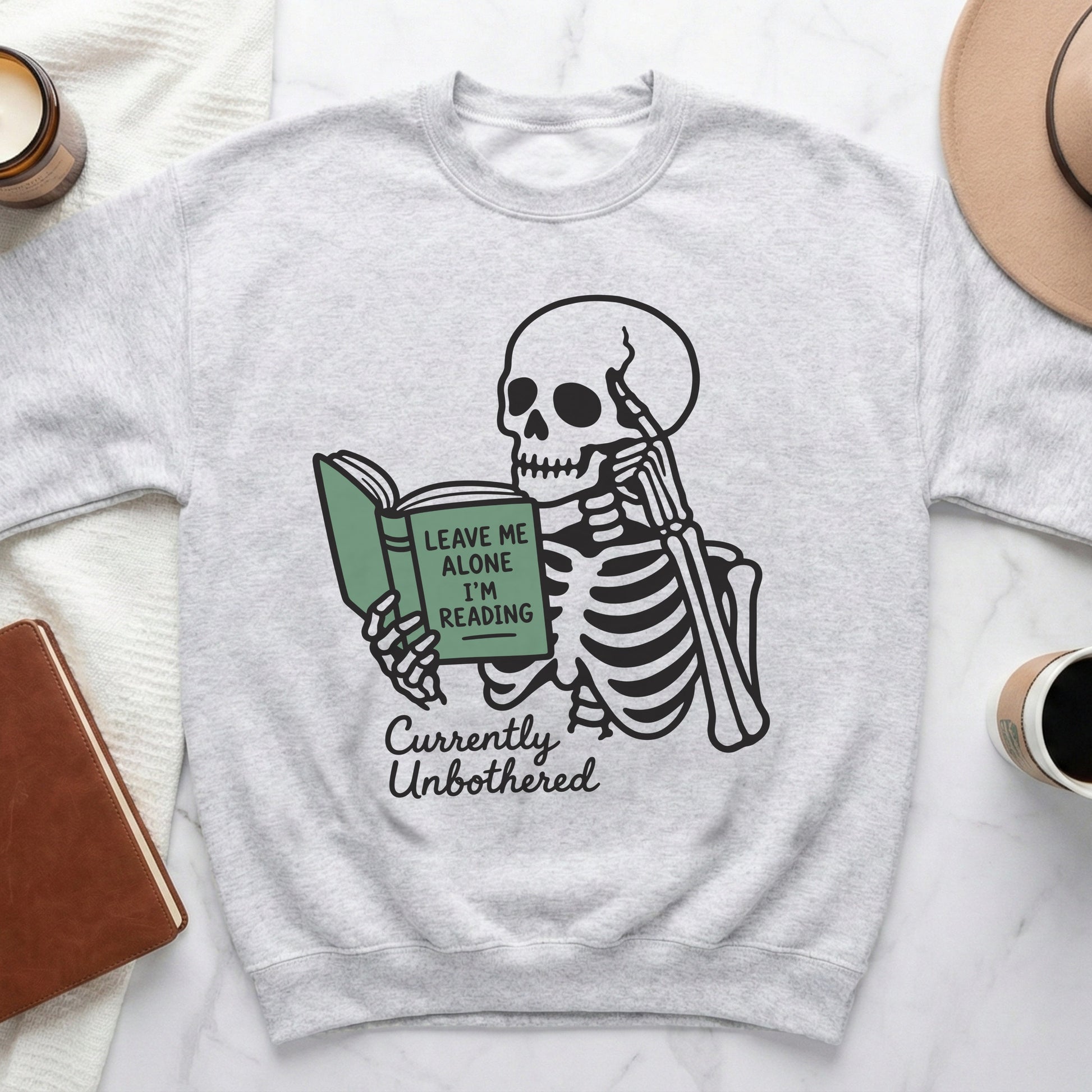 Skeleton reading a book with text "Leave me alone I'm reading".