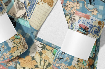 Blanket with collage of vintage stamps, flowers, books, and butterflies.