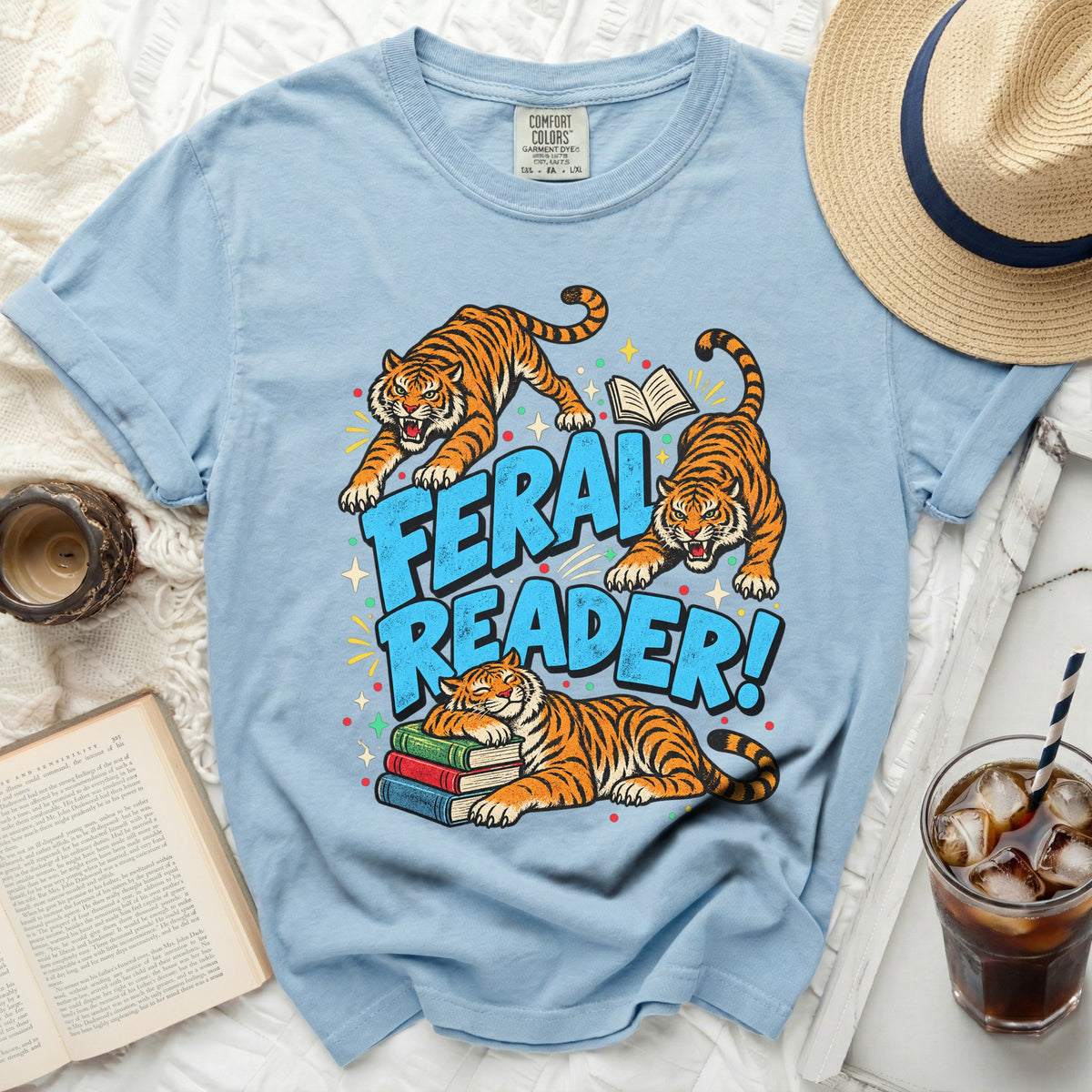 Light blue t-shirt with three tigers and the text "Feral Reader!".