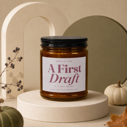 Candle with label "A First Draft It's Not Ready MagicMerchEmporium".