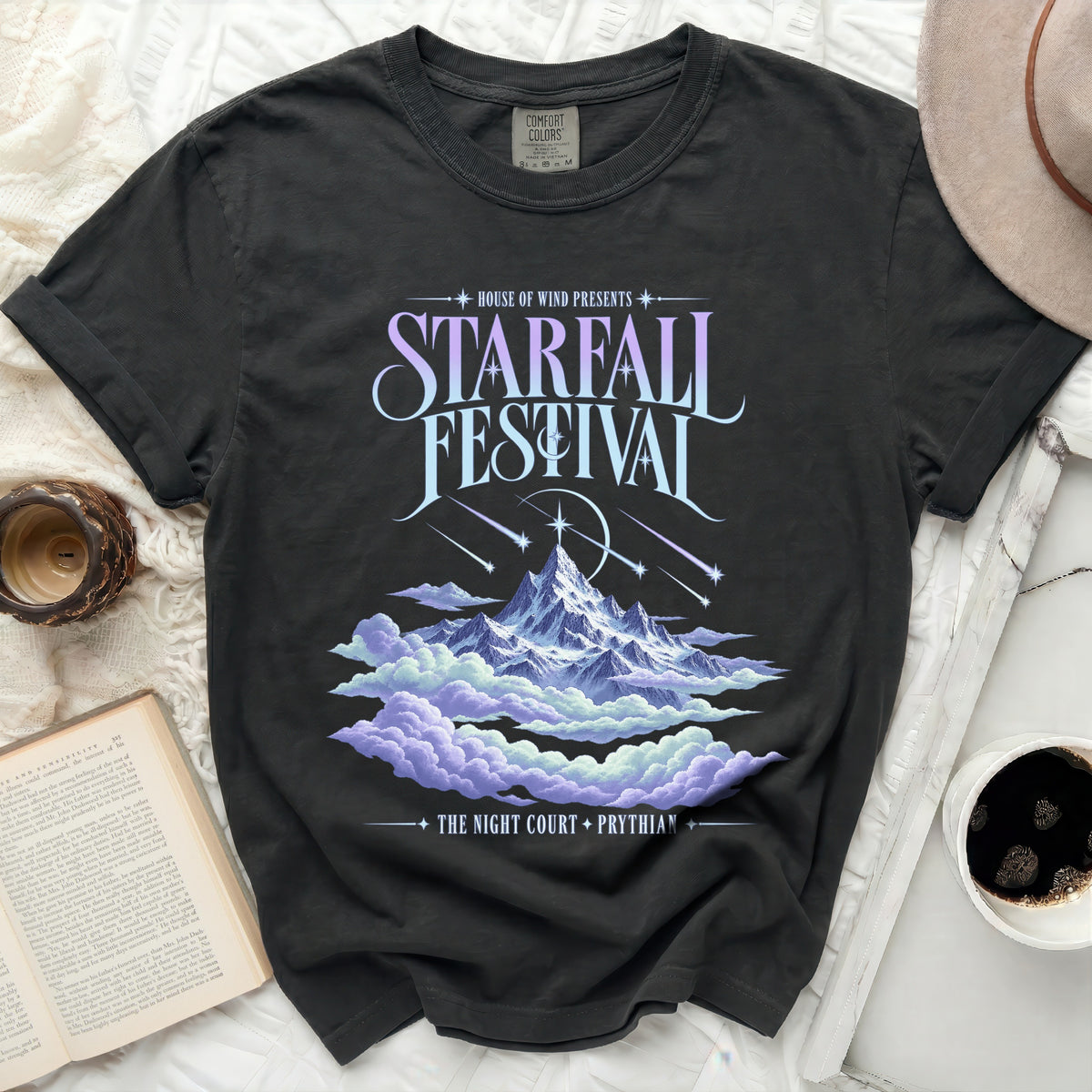 Black t-shirt with Starfall Festival graphic featuring mountains, clouds, and falling stars.