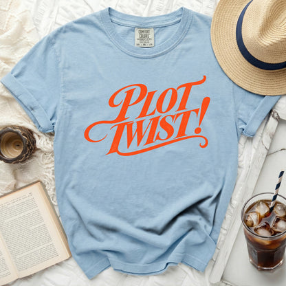 Light blue t-shirt with "PLOT TWIST!" in orange graphic text.