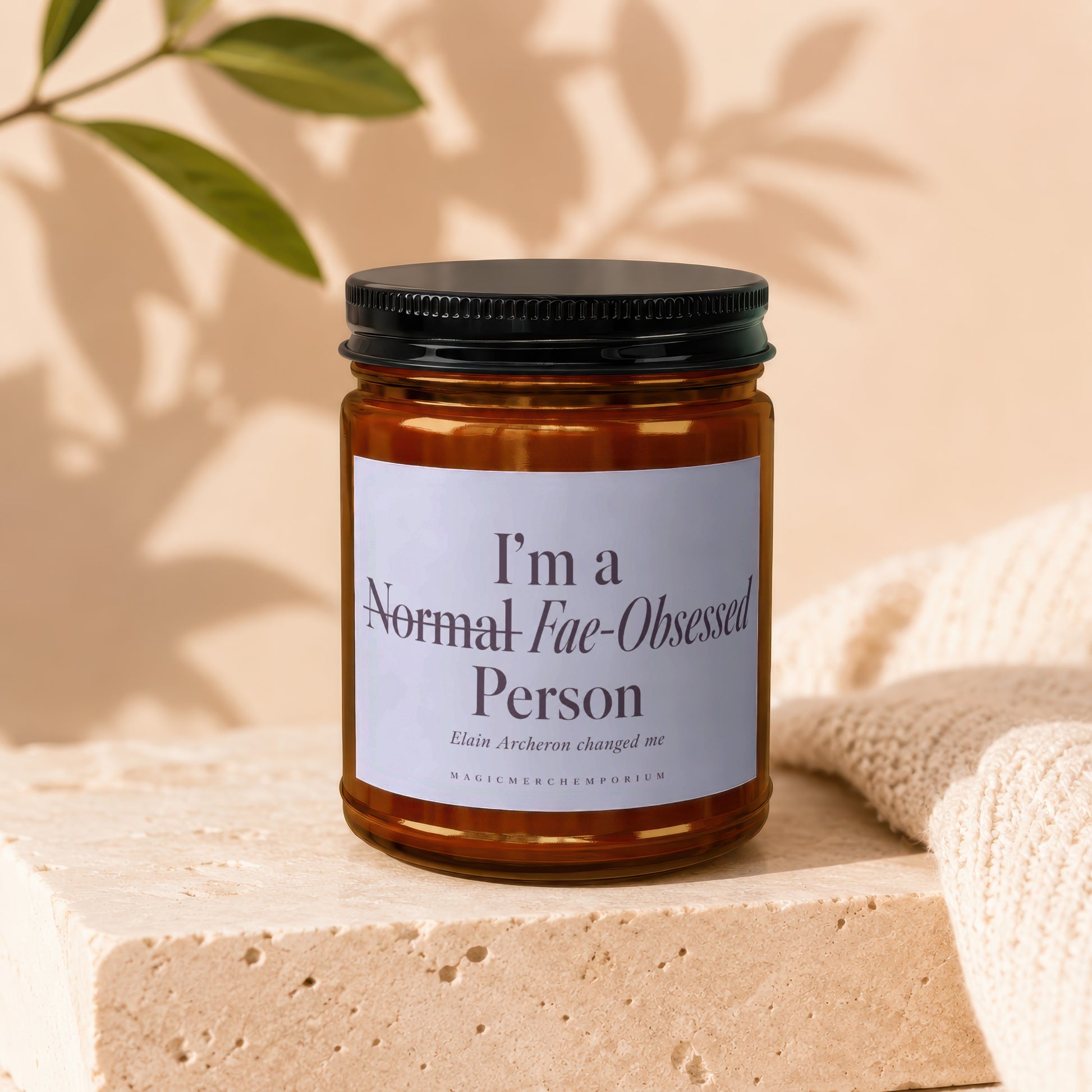 Candle with text "I'm a Normal Fae-Obsessed Person" and "MAGICMERCHEMPORIUM."
