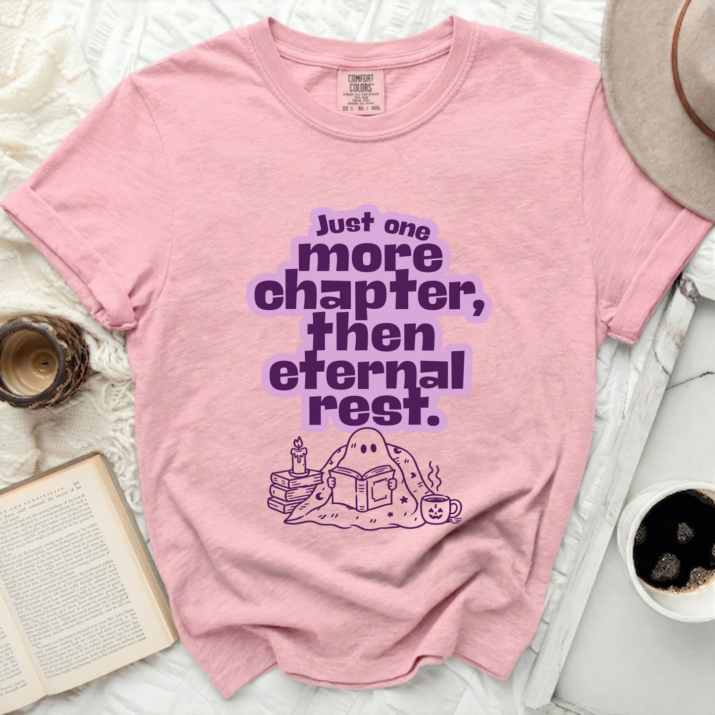 Pink t-shirt with ghost reading book and text "Just one more chapter, then eternal rest."