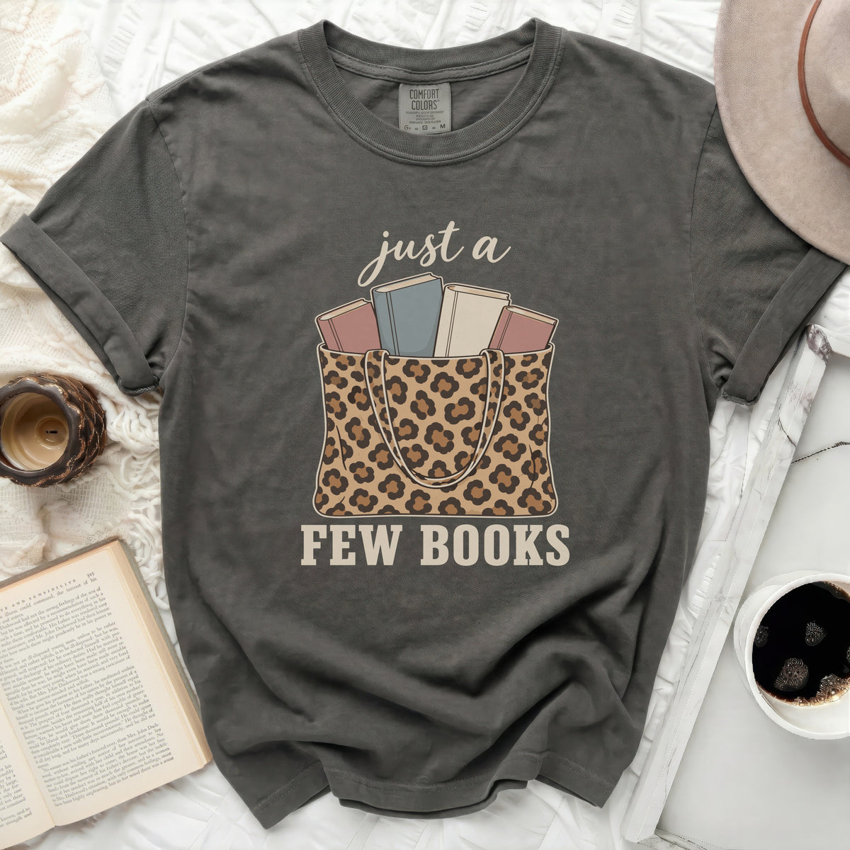 Gray t-shirt with leopard print tote bag and books graphic.