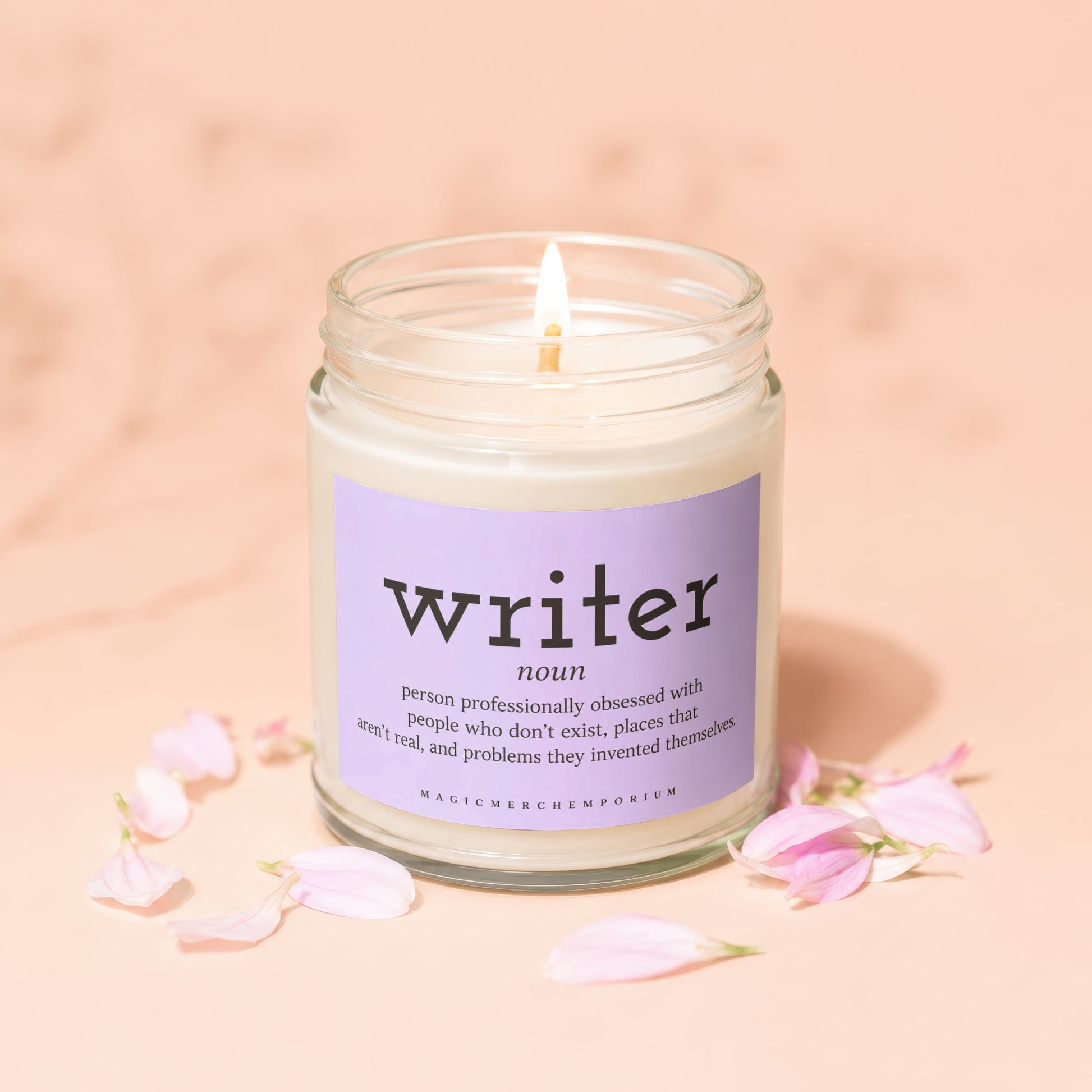 Candle with a lavender label defining "writer" and a lit wick.