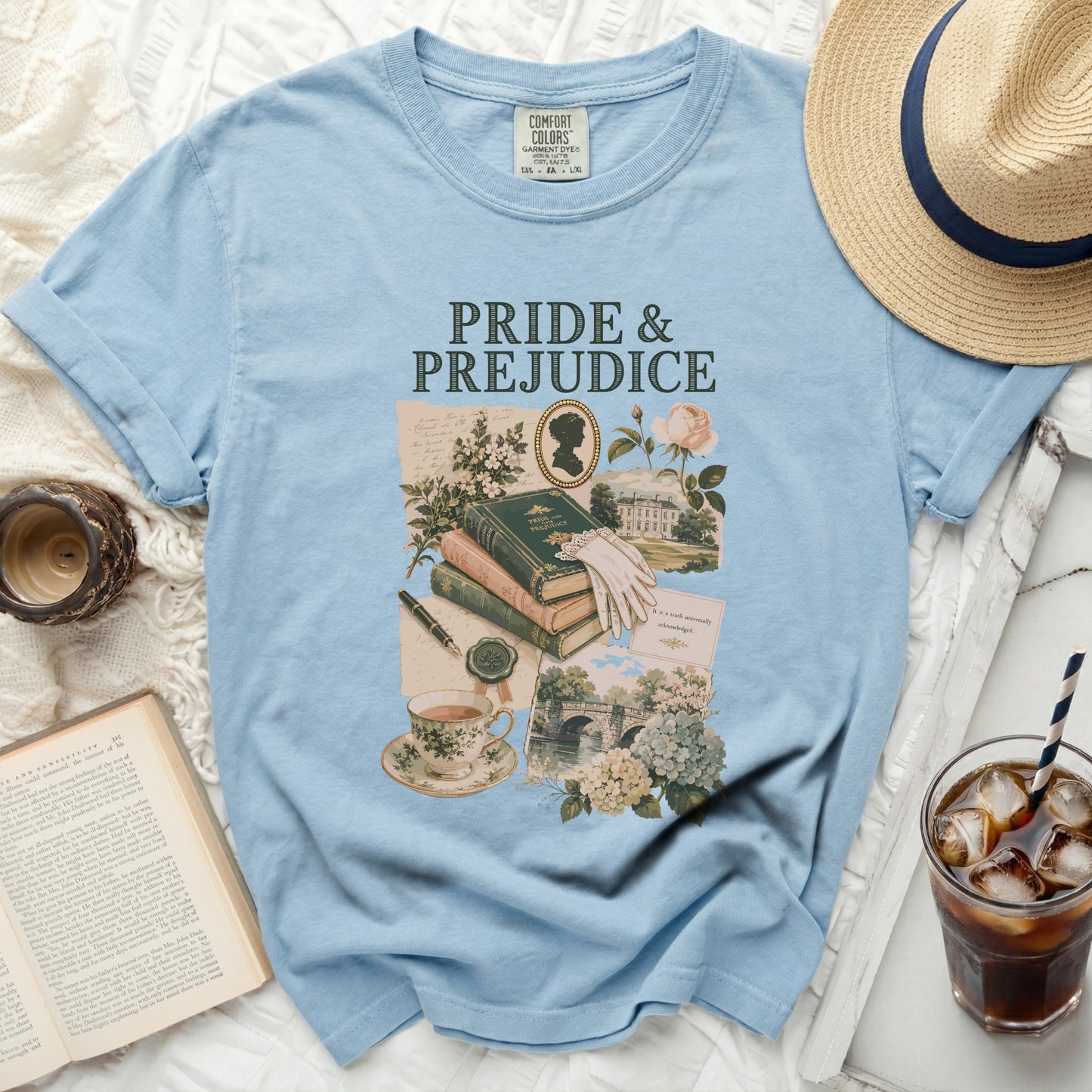 Light blue t-shirt with "Pride & Prejudice" graphic and vintage elements.