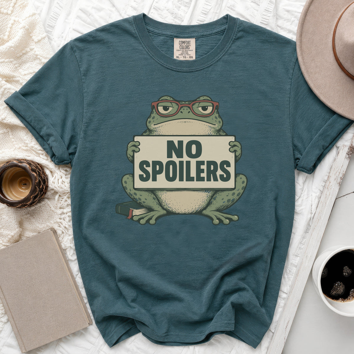 T-shirt with a frog wearing glasses holding a "No Spoilers" sign.