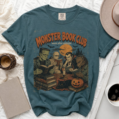 Dark teal t-shirt with "Monster Book Club" graphic of Dracula, Mummy, Frankenstein, and werewolf reading.