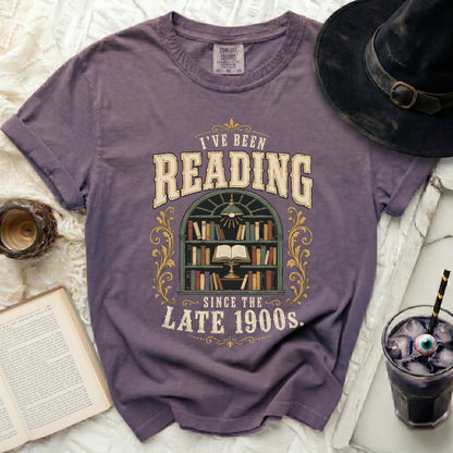 Purple t-shirt with "I've been Reading Since The Late 1900s" graphic.