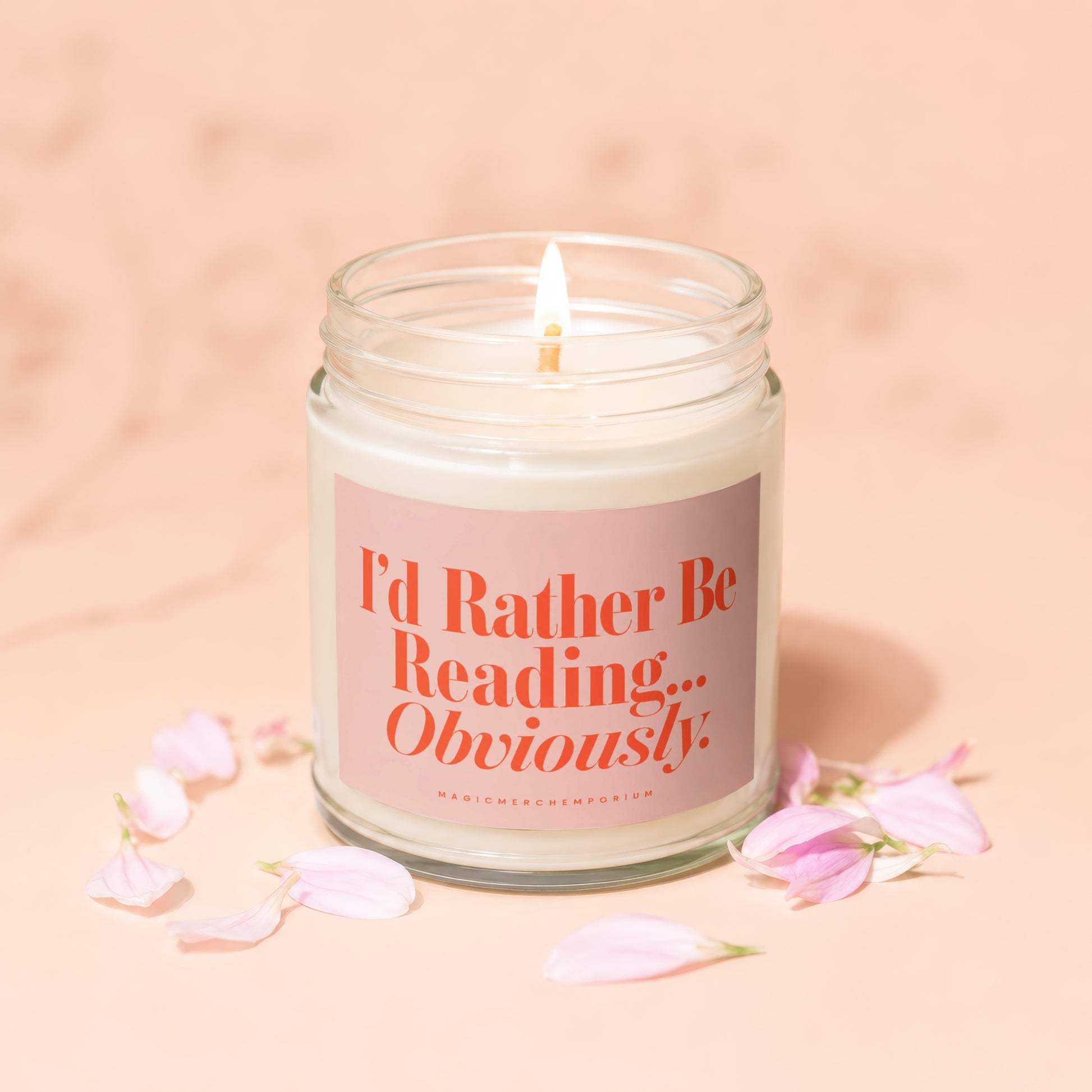 I'd Rather Be Reading... Obviously candle with pink petals and a lit wick.