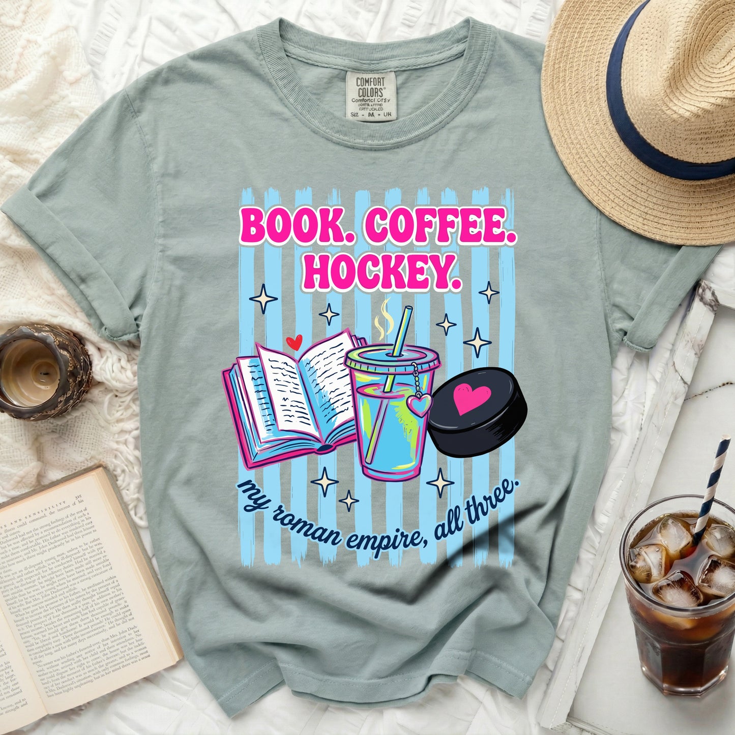Book Coffee Hockey graphic tee with striped background and text.