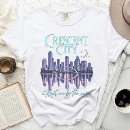 White t-shirt with "Crescent City" and "Meet me by the river" graphics.