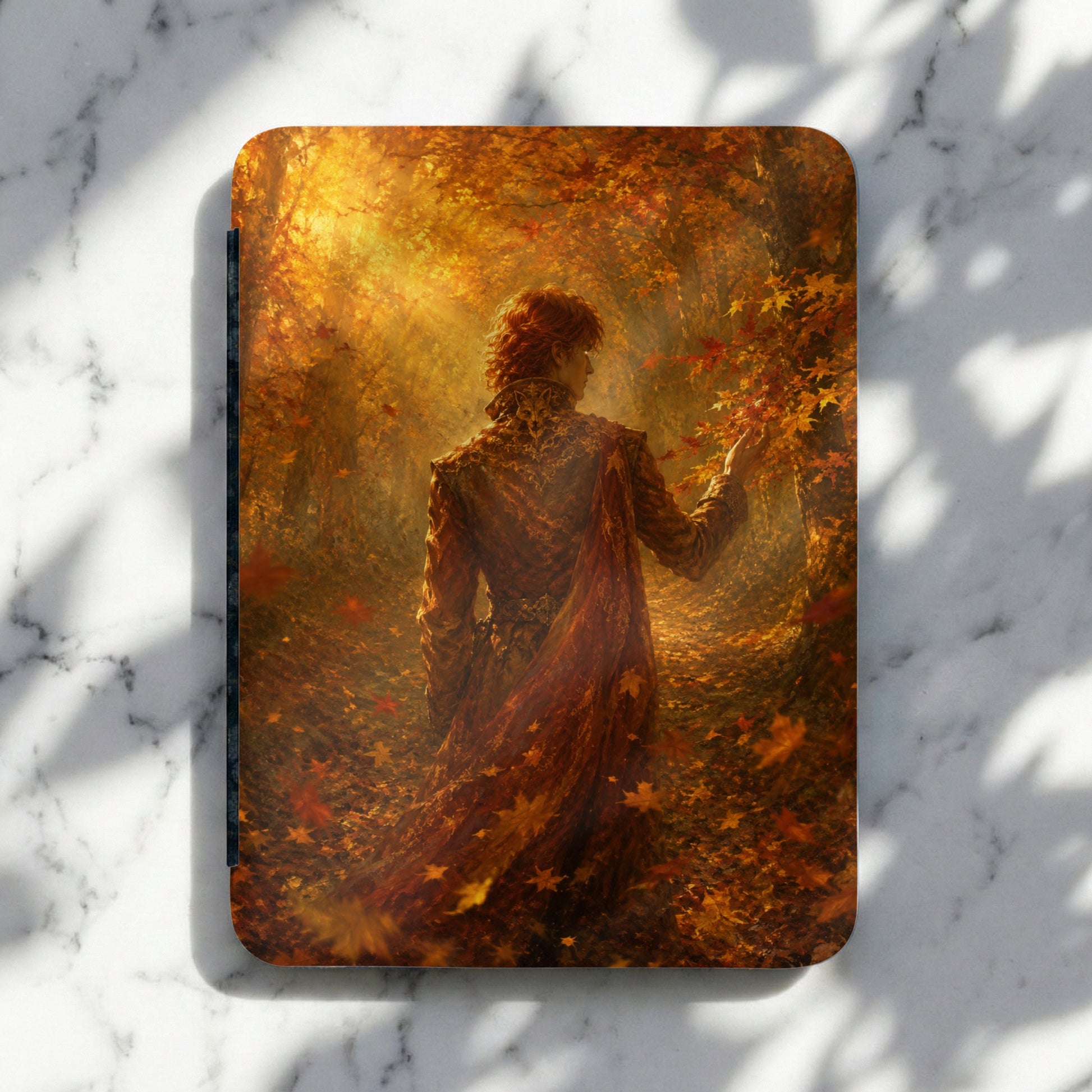 Man with red hair in ornate cloak in an autumn forest with falling leaves.