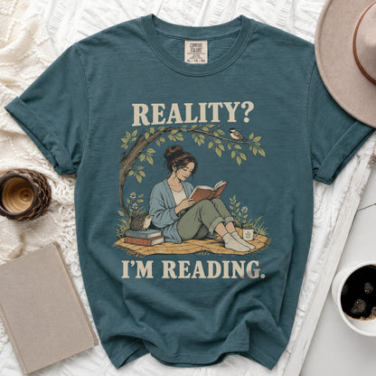 Teal Comfort Colors t-shirt with "REALITY? I'M READING." text and illustration.