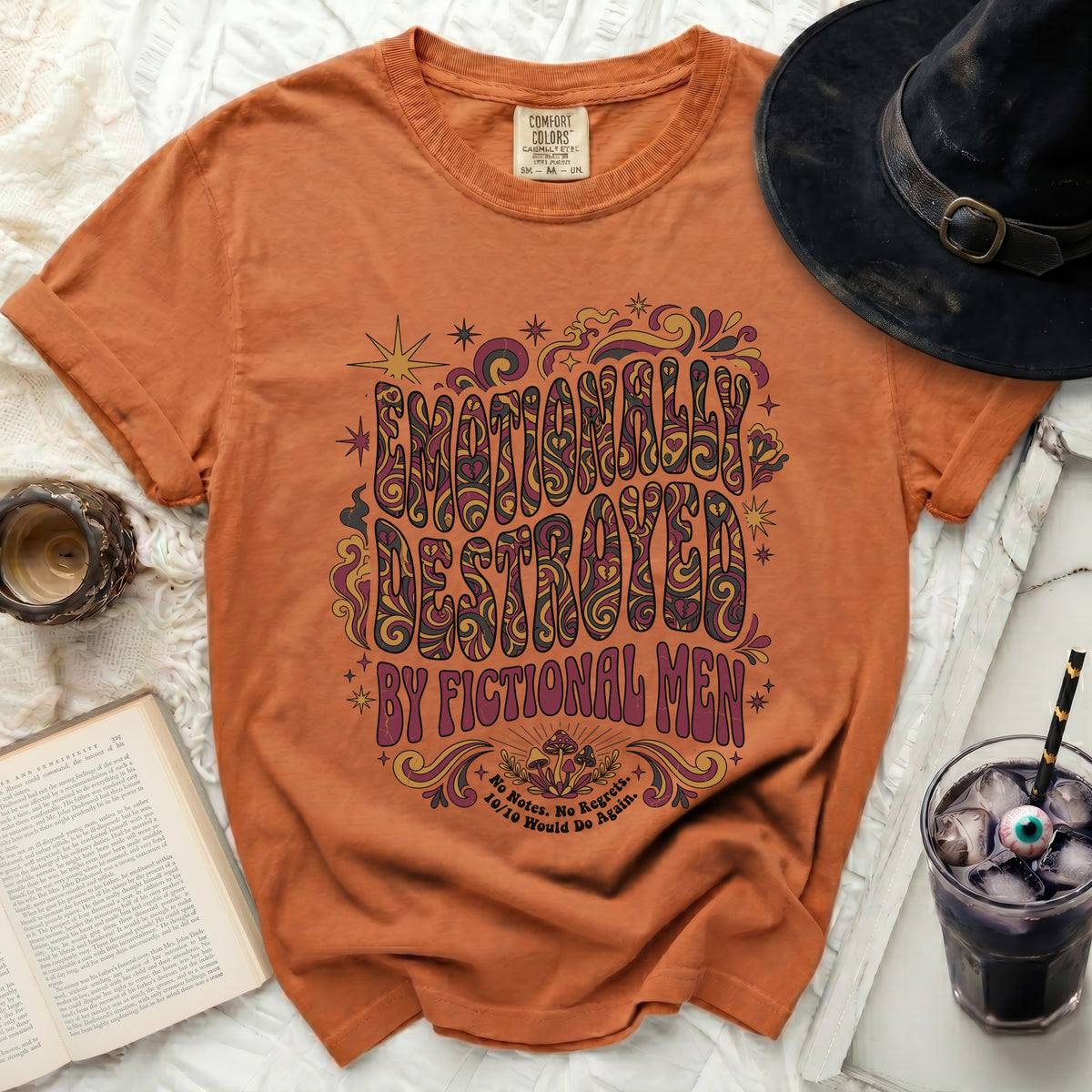 Orange t-shirt with "Emotionally Destroyed by Fictional Men" graphic.