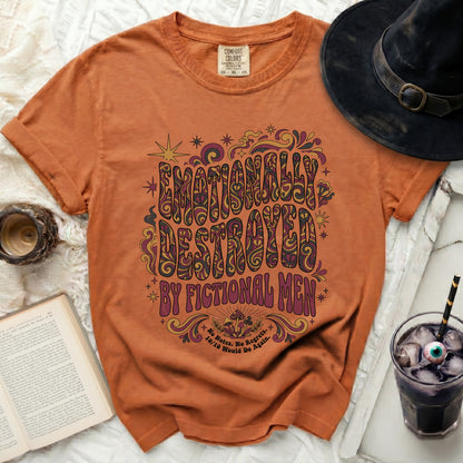 Orange t-shirt with "Emotionally Destroyed by Fictional Men" graphic.