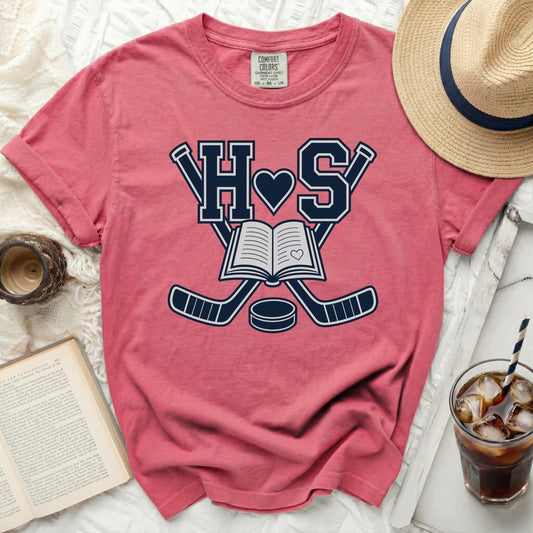 Pink t-shirt with hockey sticks, book, and "HS" heart graphic.