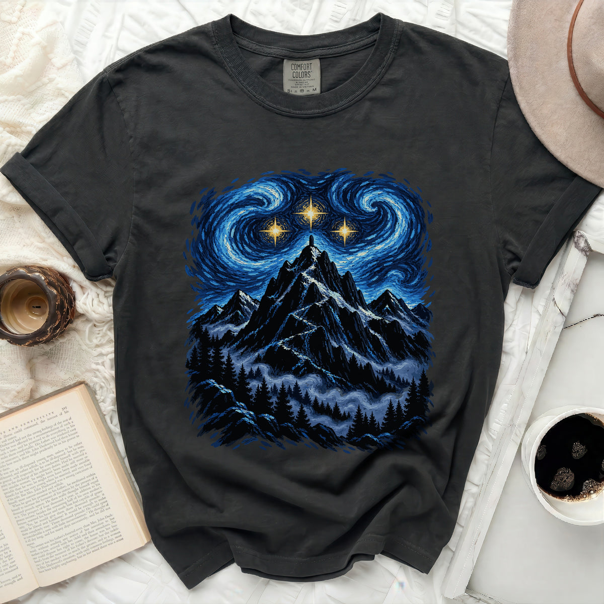 Dark grey t-shirt with a starry night mountain landscape graphic and Comfort Colors tag.