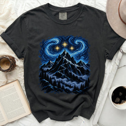 Dark grey t-shirt with a starry night mountain landscape graphic and Comfort Colors tag.