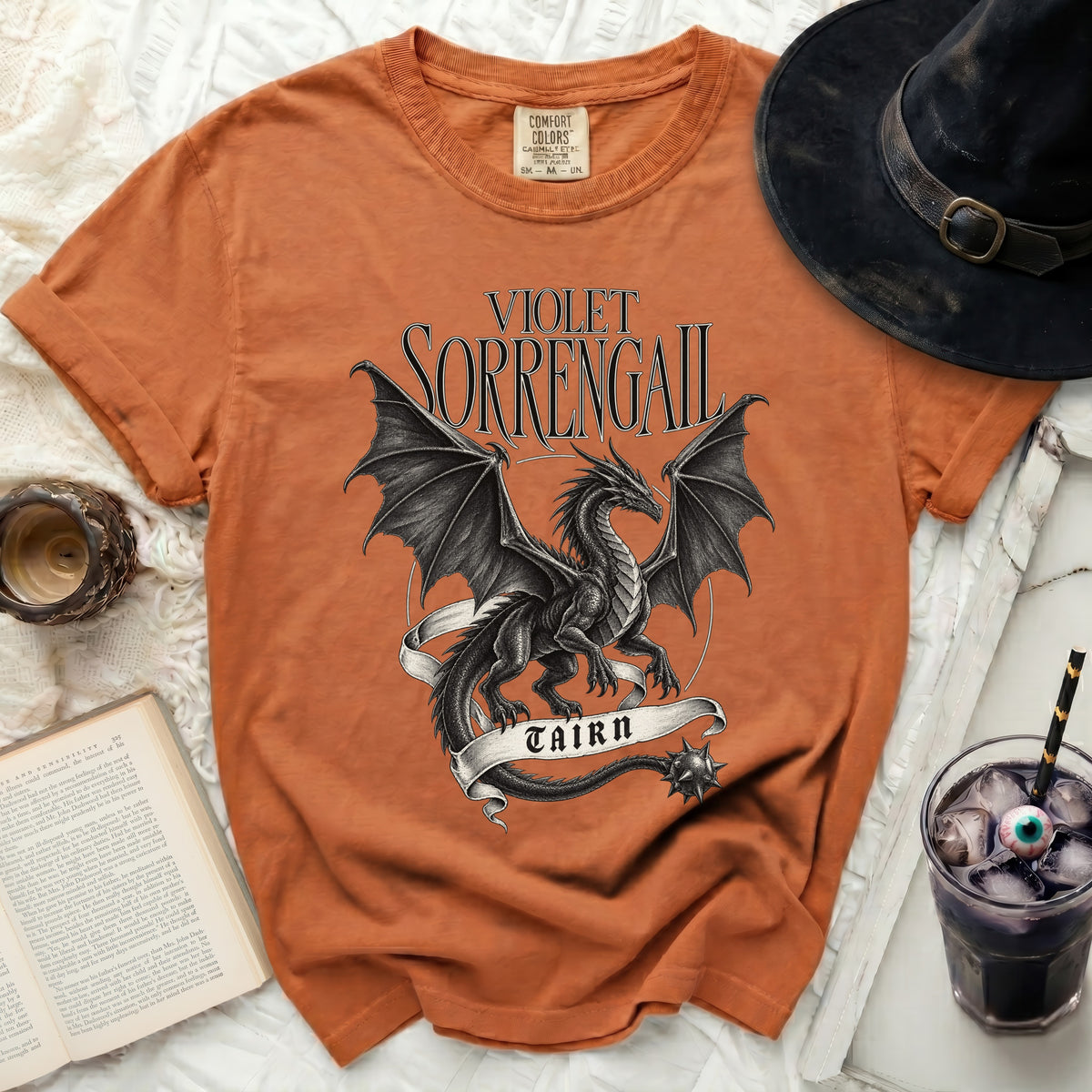 Orange t-shirt with a black dragon design and text "VIOLET SORRENGAIL TAIRN".