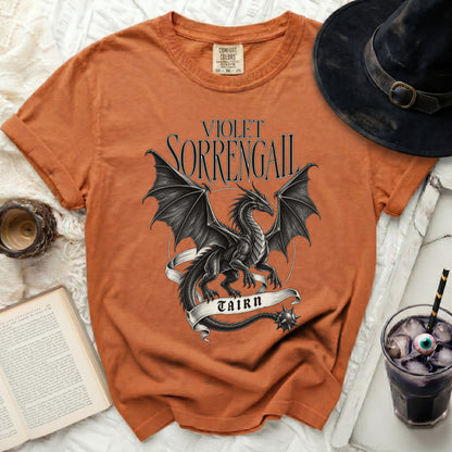 Orange t-shirt with a black dragon design and text "VIOLET SORRENGAIL TAIRN".