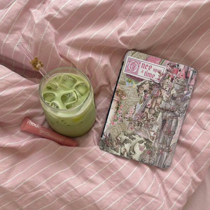 Green iced beverage, pink lip balm, and fairytale journal with text "once upon a time".