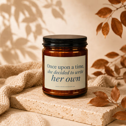 Amber candle with black lid displaying quote "Once upon a time, she decided to write her own".