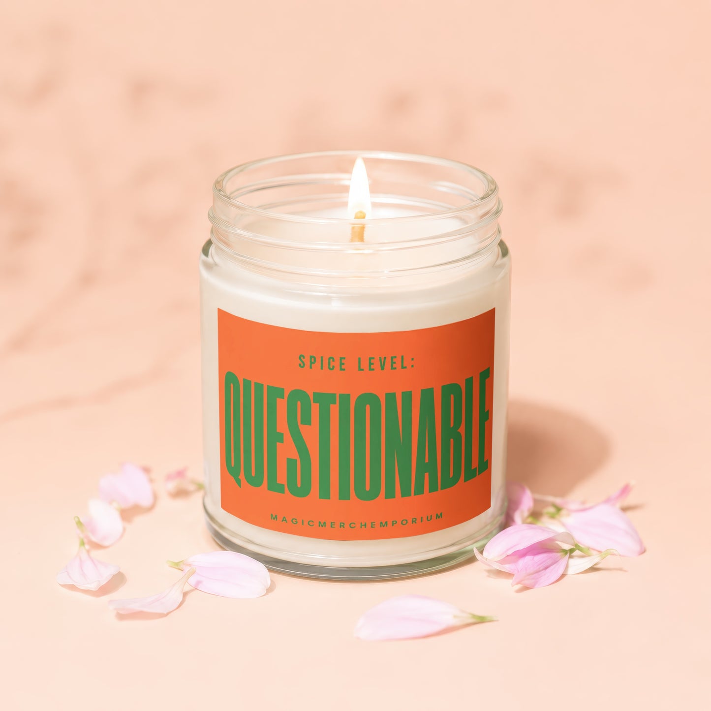Glass jar candle with label reading "Spice Level: Questionable" and "MagicMerchEmporium".