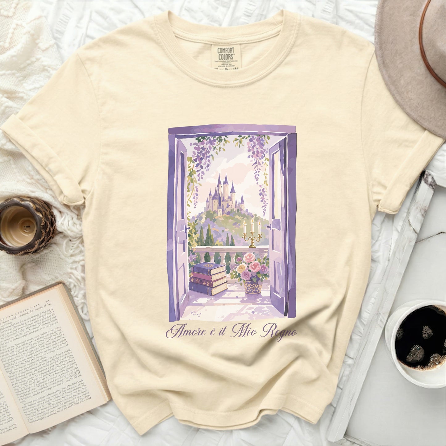 Cream t-shirt with watercolor print of castle through open window and text "Amore è il Mio Regno".