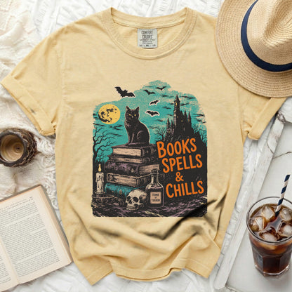 Yellow t-shirt with "Books Spells & Chills" graphic featuring a black cat.