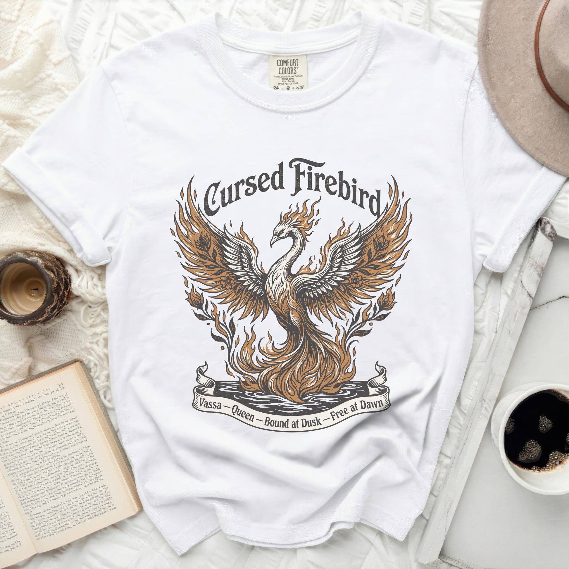 White t-shirt with a graphic of a fiery phoenix and text "Cursed Firebird."