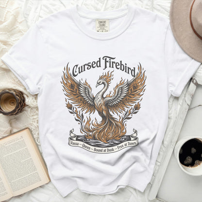 White t-shirt with a graphic of a fiery phoenix and text "Cursed Firebird."