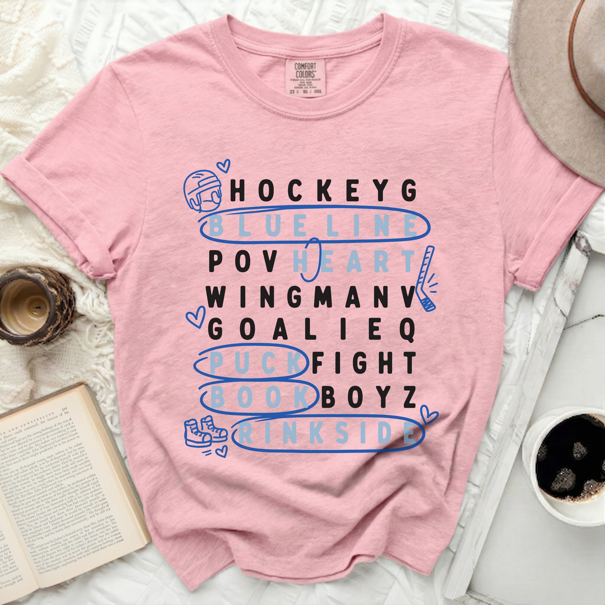Pink t-shirt with "Hockey" themed word art in blue and white.