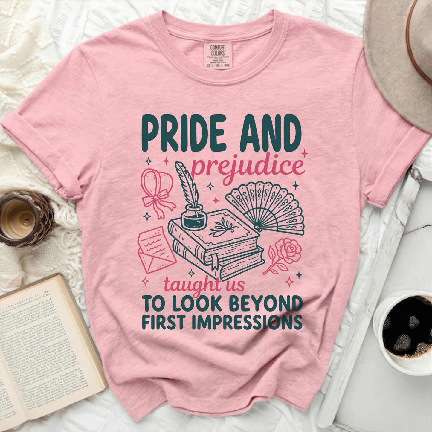 Pink t-shirt with "Pride and Prejudice Taught Us To Look Beyond First Impressions" graphic.