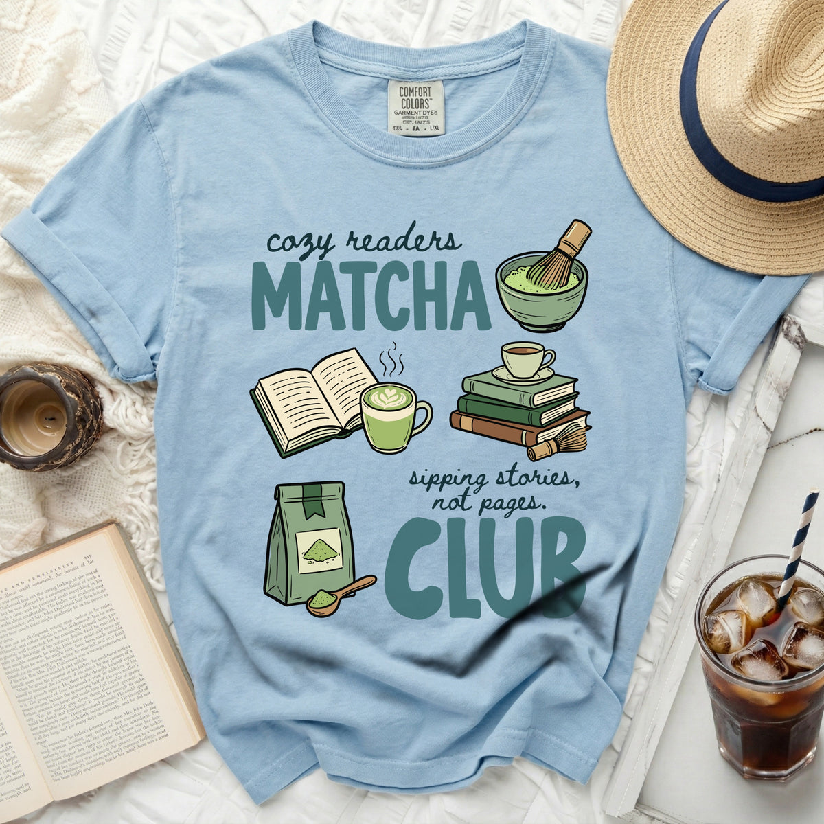 Light blue t-shirt with "cozy readers MATCHA sipping stories, not pages. CLUB" graphic.
