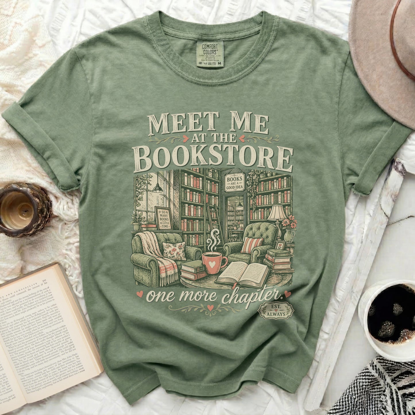 Green t-shirt with "Meet Me at the Bookstore" and book-themed graphics.