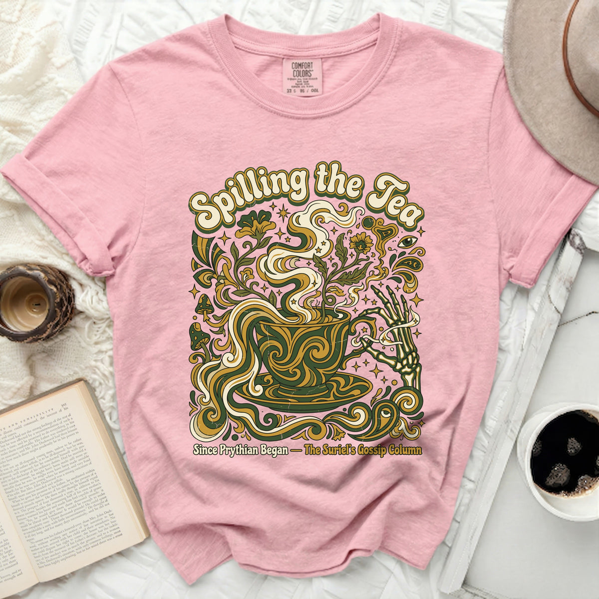 Pink t-shirt with "Spilling the Tea" and skeleton hand holding a teacup graphic.