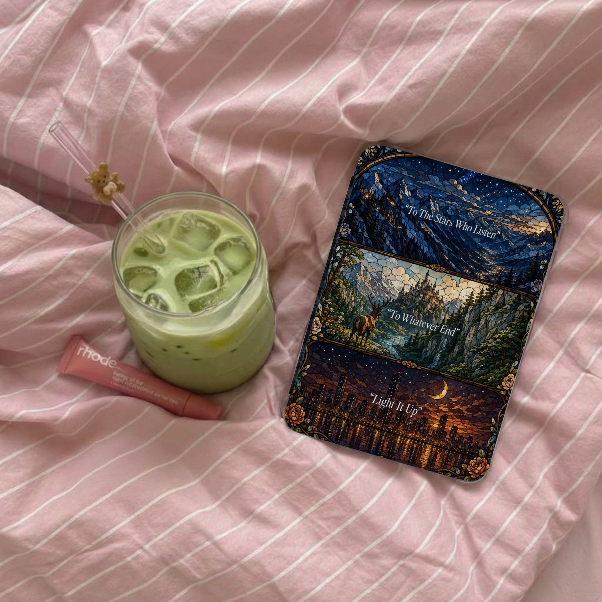 Phone case featuring starry mountains, castle, and city. Rhode lip balm.