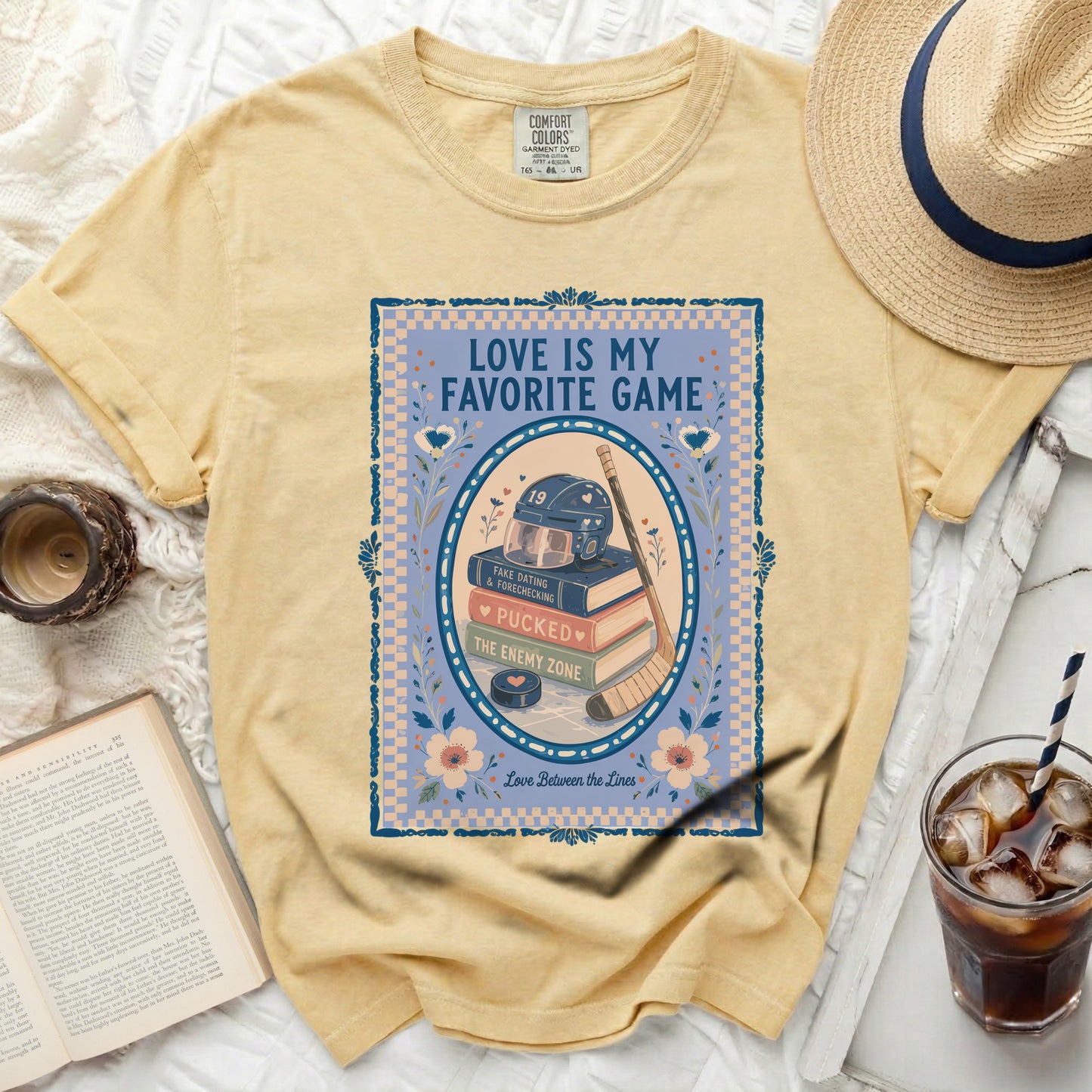 Yellow t-shirt with "Love is my favorite game" hockey graphic and book.