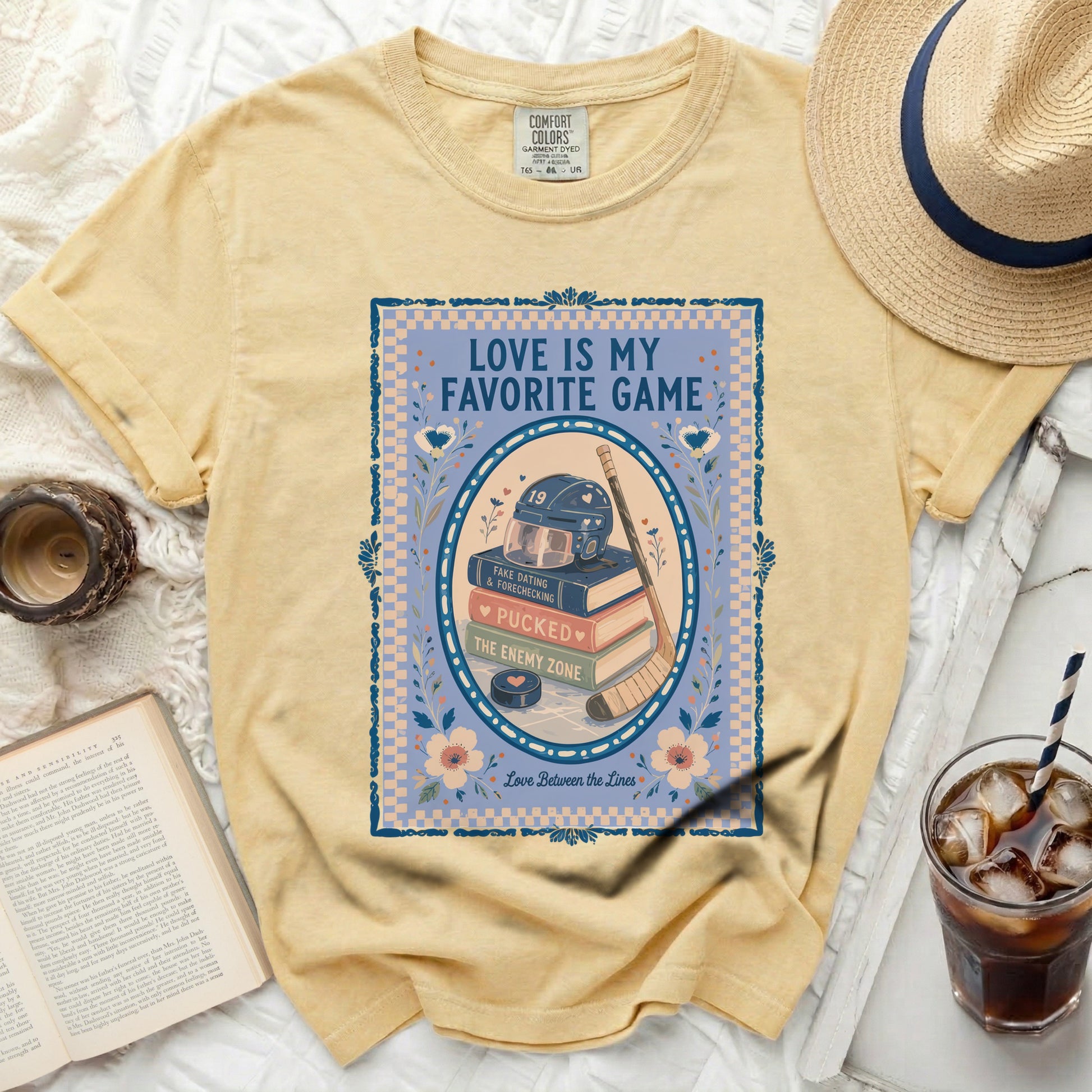 Yellow t-shirt with "Love is my favorite game" hockey graphic and book.