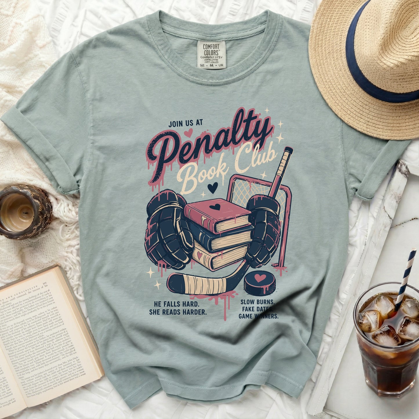 T-shirt with "Penalty Book Club" text, hockey gear, and books.